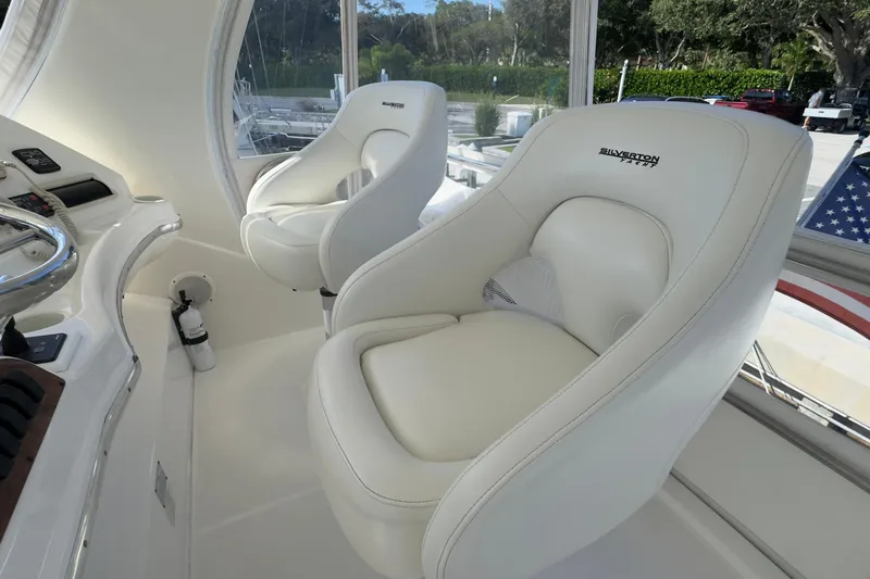  Yacht Photos Pics Luxury seating on 2004 Silverton 38 Convertible yacht, featuring plush white captain's chairs.