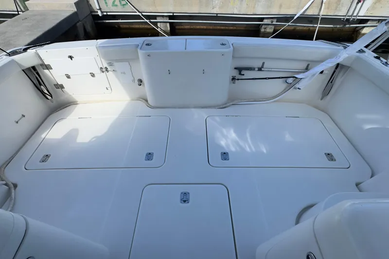  Yacht Photos Pics 2004 Silverton 38 Convertible boat deck with storage compartments and clean white finish.