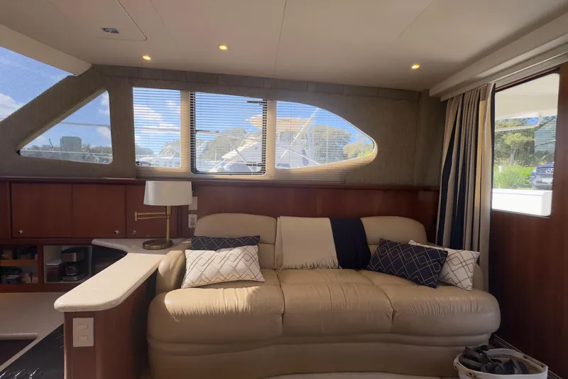  Yacht Photos Pics Interior of 2004 Silverton 38 Convertible yacht with beige sofa and decorative pillows.