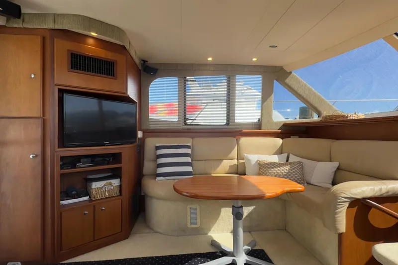  Yacht Photos Pics Interior of 2004 Silverton 38 Convertible yacht with cozy seating and entertainment area.