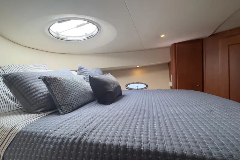  Yacht Photos Pics Luxurious cabin interior of 2004 Silverton 38 Convertible yacht with plush bedding.