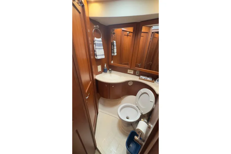  Yacht Photos Pics Luxurious bathroom in 2004 Silverton 38 Convertible yacht with wood cabinetry and modern fixtures.