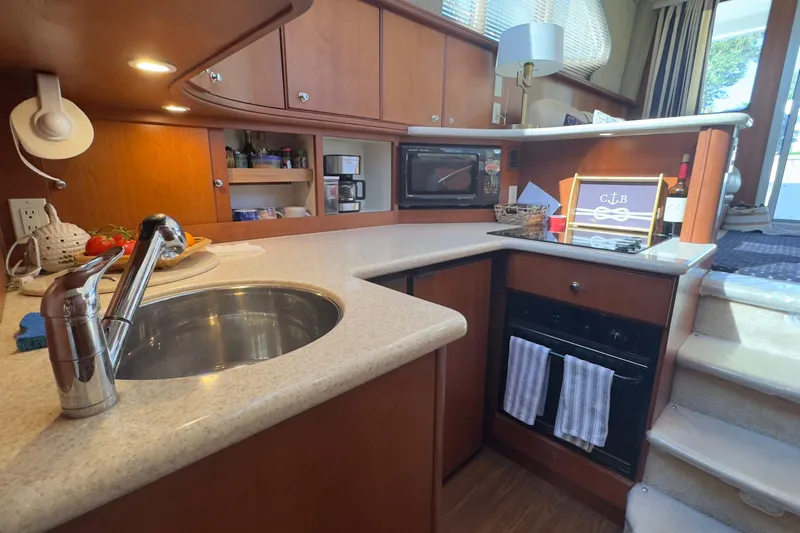  Yacht Photos Pics 2004 Silverton 38 Convertible yacht kitchen with modern amenities and wooden cabinetry.