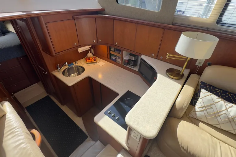  Yacht Photos Pics 2004 Silverton 38 Convertible yacht interior with kitchenette, sink, and seating area.