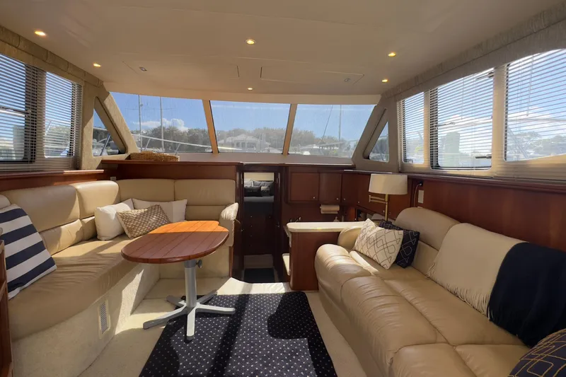  Yacht Photos Pics Luxurious interior of 2004 Silverton 38 Convertible yacht with plush seating and elegant decor.