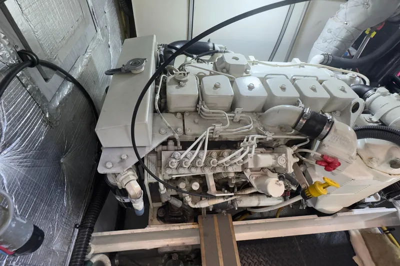  Yacht Photos Pics Engine compartment of a 2004 Silverton 38 Convertible boat, showcasing detailed machinery.