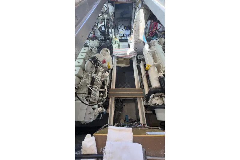  Yacht Photos Pics Engine room of a 2004 Silverton 38 Convertible boat, showcasing dual engines.