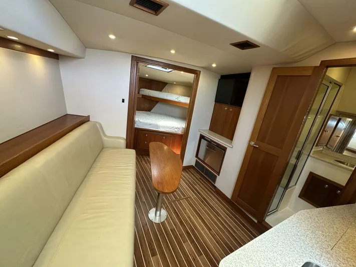 Squid Inc Yacht Photos Pics 2007 Albemarle 360 Express interior with beige seating, wooden accents, and bunk beds.