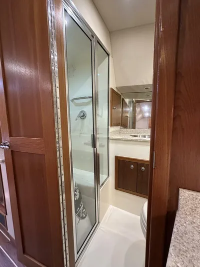 Squid Inc Yacht Photos Pics 2007 Albemarle 360 Express yacht bathroom with shower and wooden cabinetry.