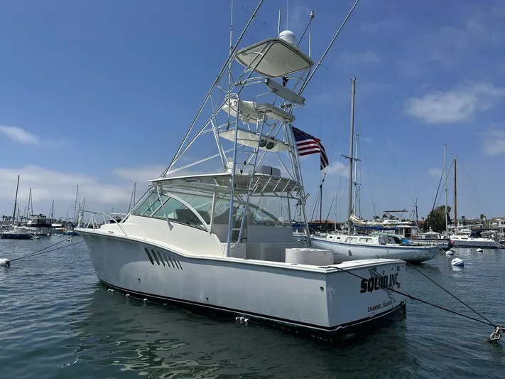 Squid Inc Yacht Photos Pics 2007 Albemarle 360 Express boat docked in a marina, featuring a tower and American flag.