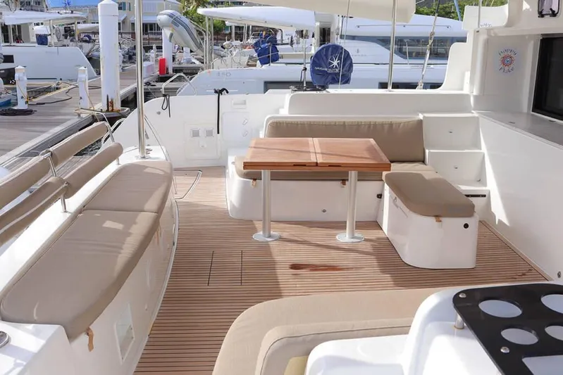  Yacht Photos Pics Spacious deck of 2023 Lagoon 46 catamaran with seating and wooden table.