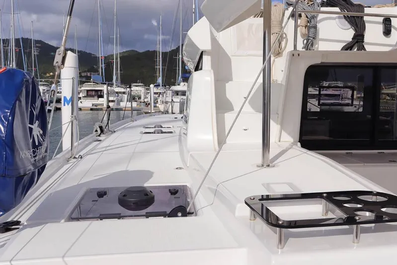  Yacht Photos Pics 2023 Lagoon 46 yacht deck with marina view, featuring sleek design and modern amenities.