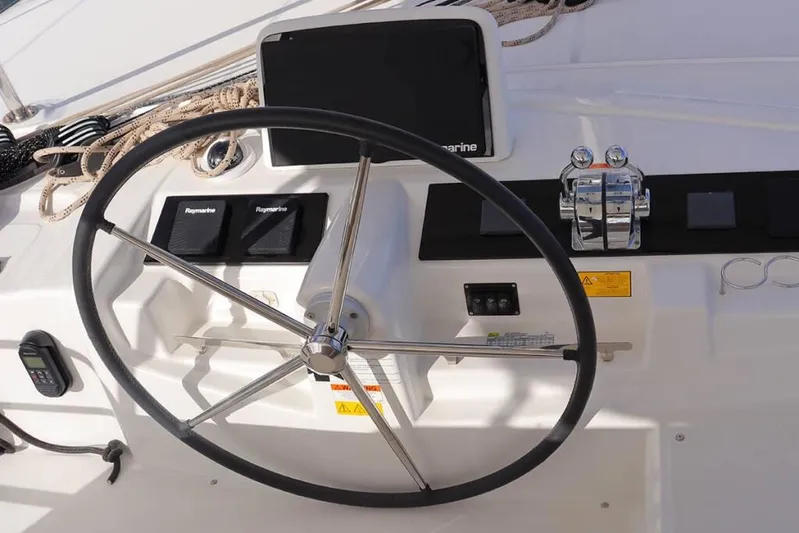  Yacht Photos Pics Steering wheel and controls of 2023 Lagoon 46 catamaran, featuring Raymarine equipment.