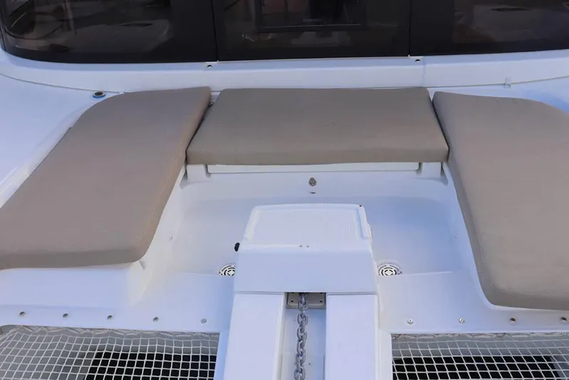  Yacht Photos Pics 2023 Lagoon 46 catamaran deck with beige cushions and chain locker.