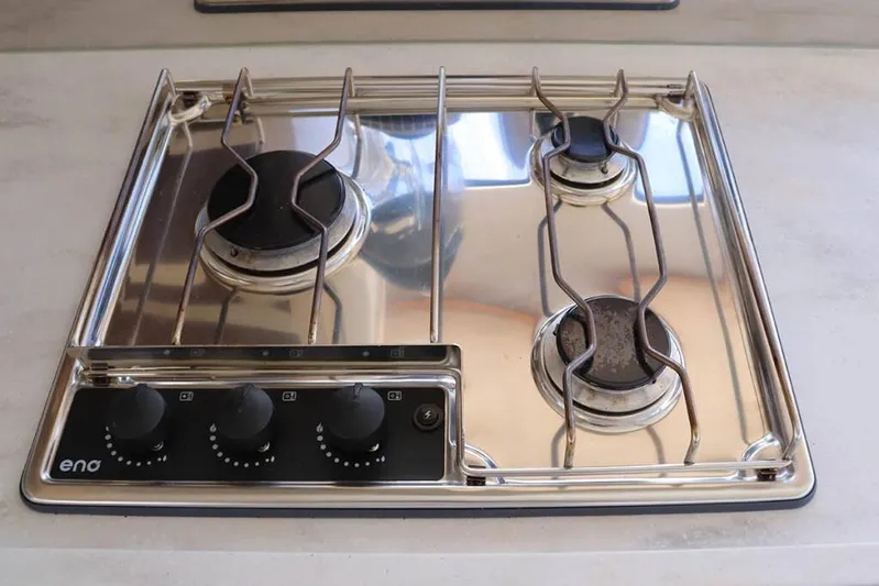  Yacht Photos Pics Three-burner stainless steel stove on 2023 Lagoon 46 yacht kitchen.