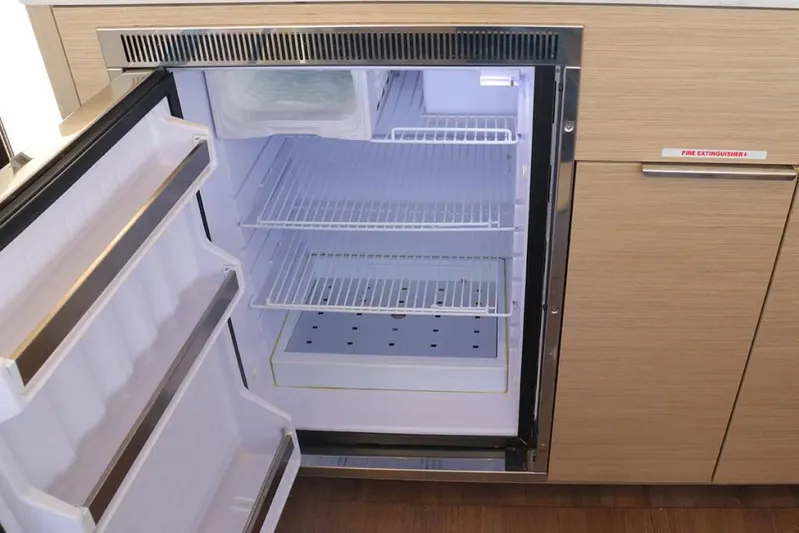  Yacht Photos Pics Open refrigerator in 2023 Lagoon 46 yacht, showcasing spacious interior and modern design.