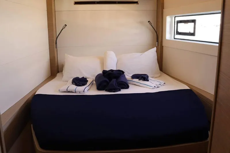  Yacht Photos Pics Luxurious cabin interior of 2023 Lagoon 46 yacht with neatly arranged bedding.