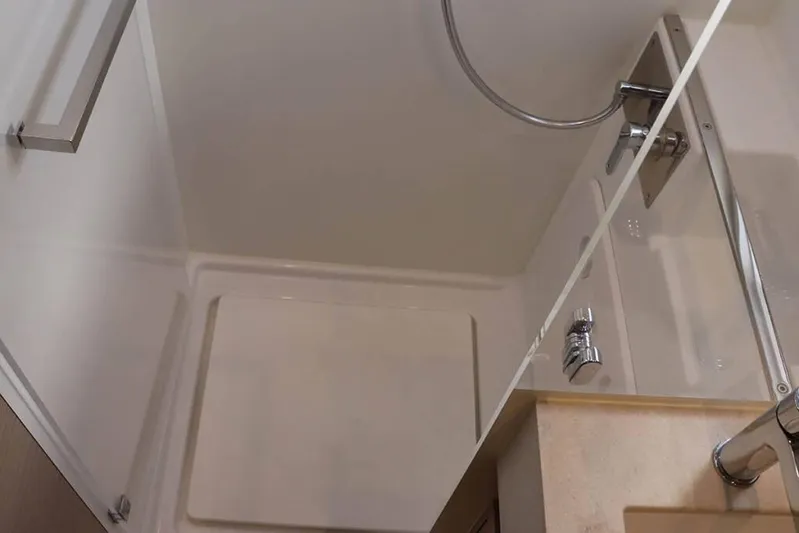  Yacht Photos Pics Modern shower area in 2023 Lagoon 46 yacht, featuring sleek fixtures and minimalist design.