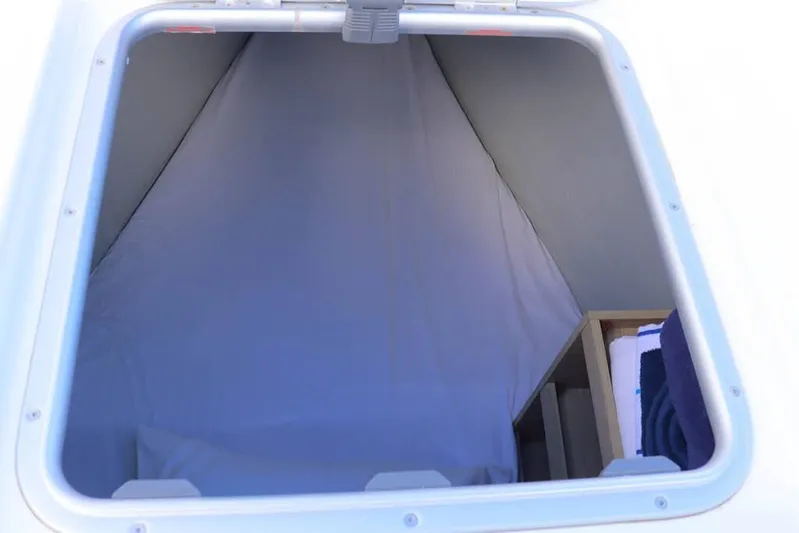  Yacht Photos Pics 2023 Lagoon 46 yacht cabin interior with bedding and storage space.