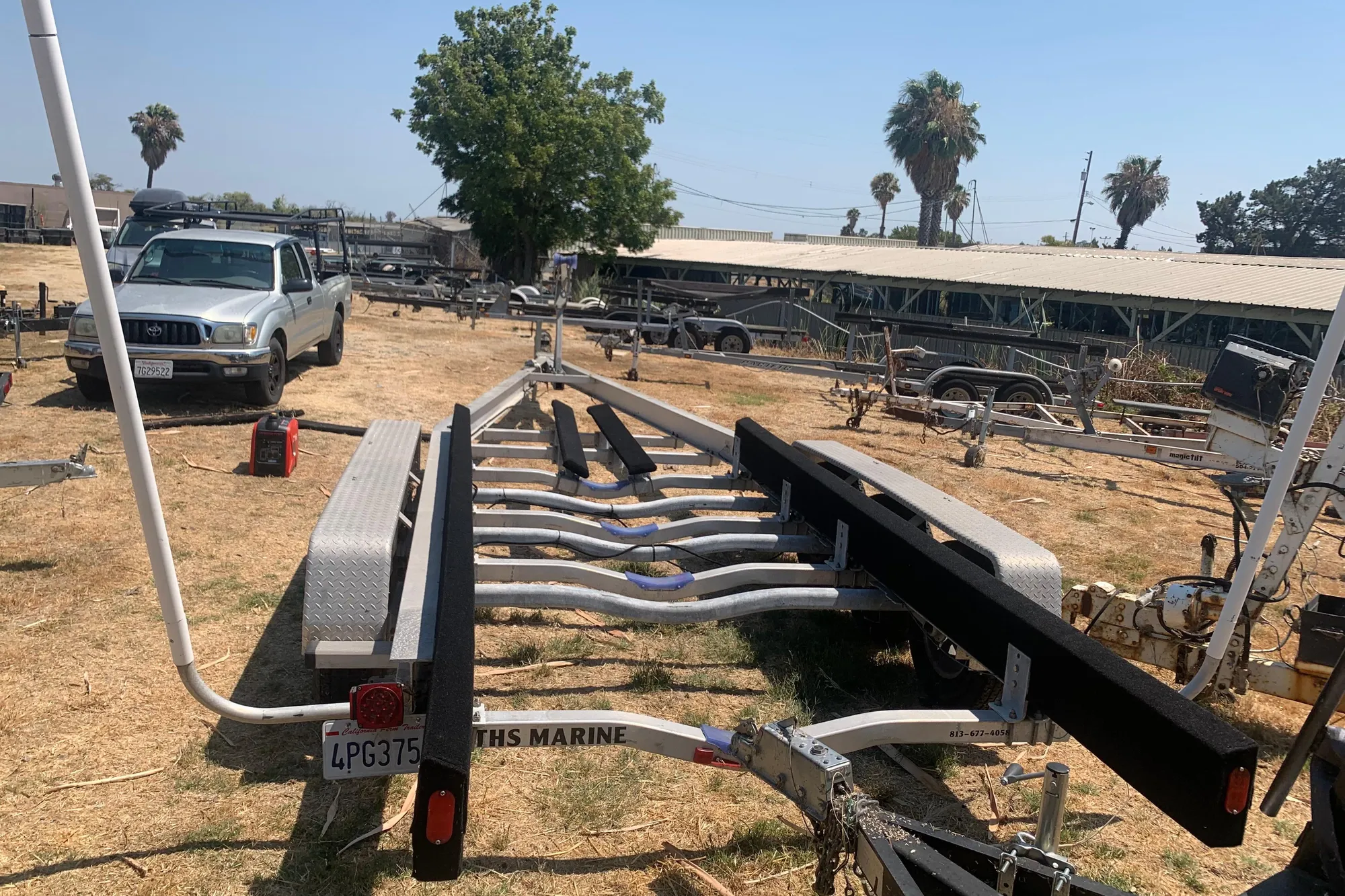 Trailer for 2001 Boston Whaler 28 Outrage in outdoor storage lot.