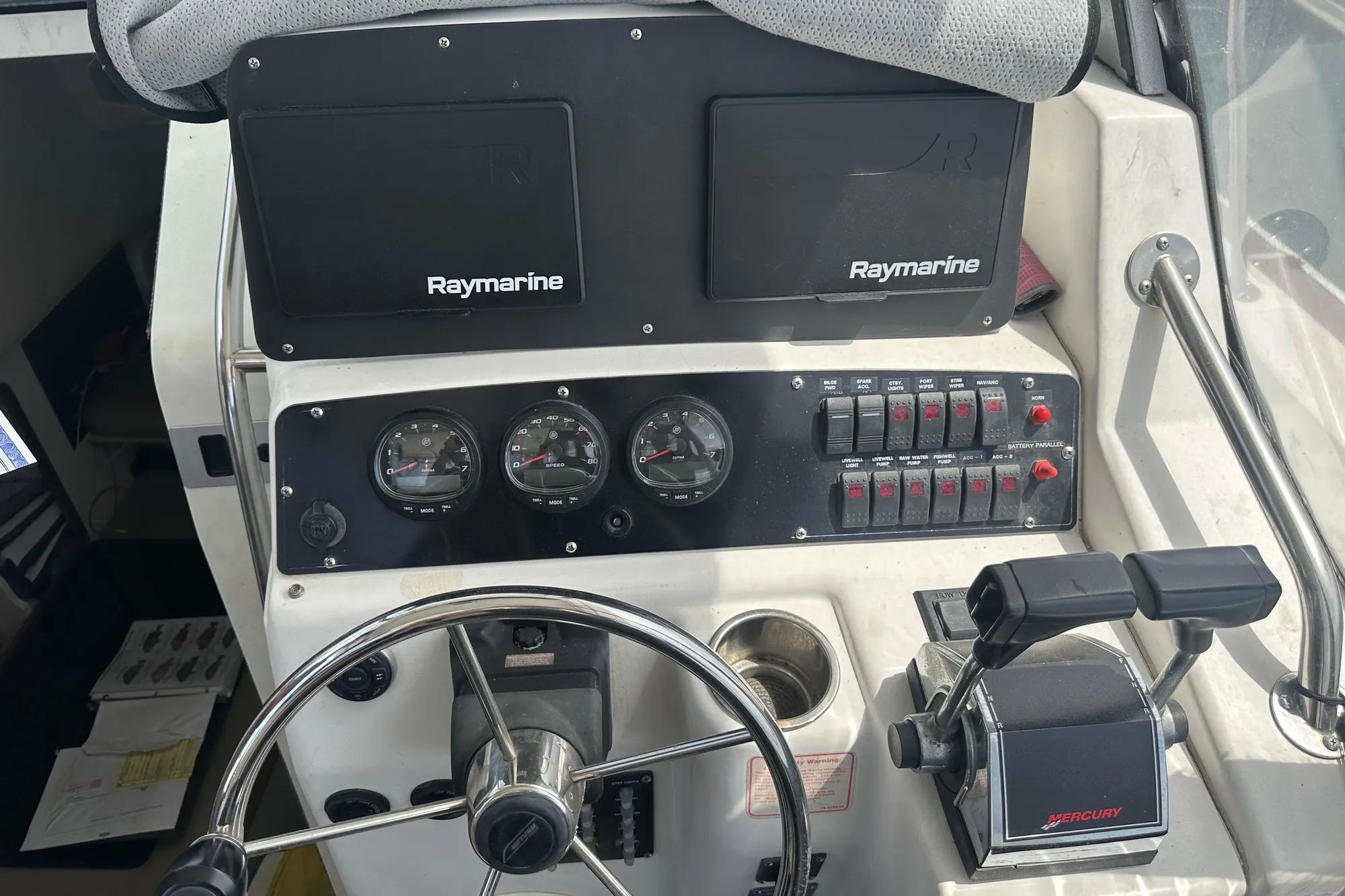 Boston Whaler 28 Outrage 2001 boat dashboard with Raymarine electronics and Mercury controls.