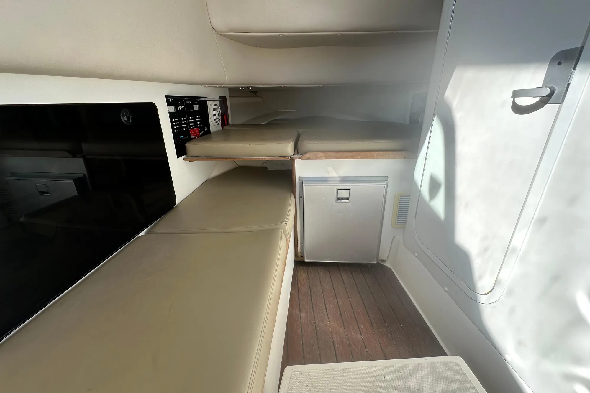 Interior cabin of 2001 Boston Whaler 28 Outrage with seating and storage.