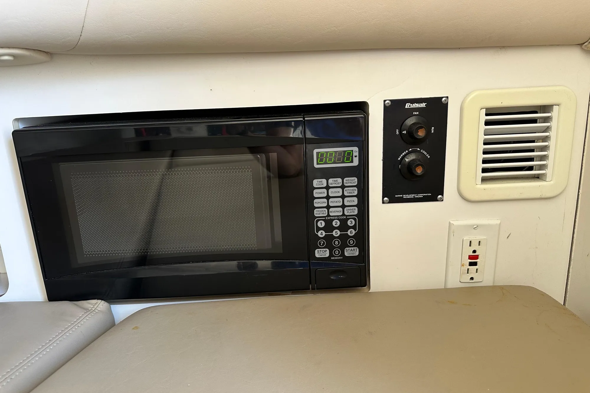 Microwave and control panel inside 2001 Boston Whaler 28 Outrage boat cabin.