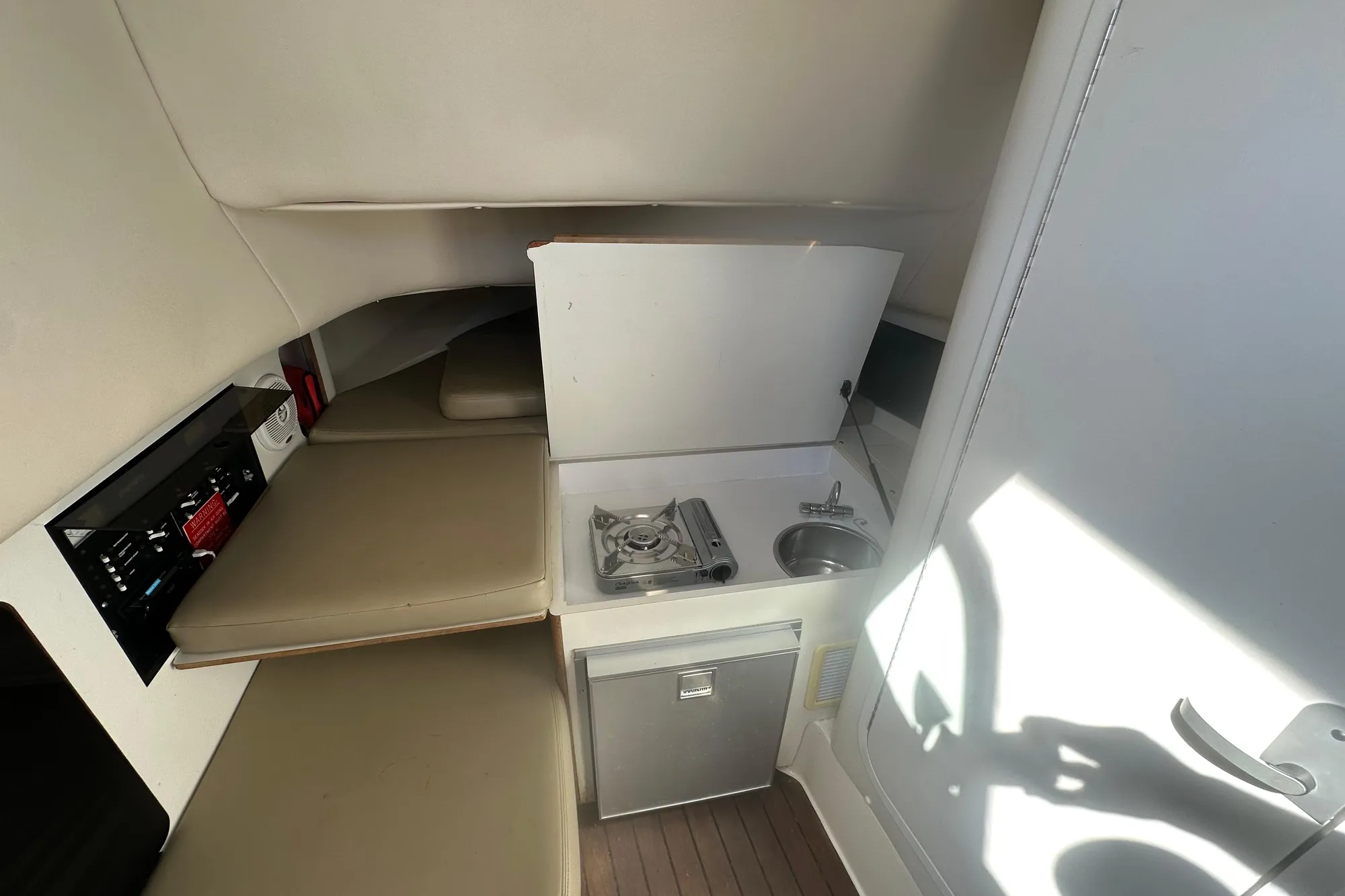 2001 Boston Whaler 28 Outrage cabin interior with kitchenette and seating area.