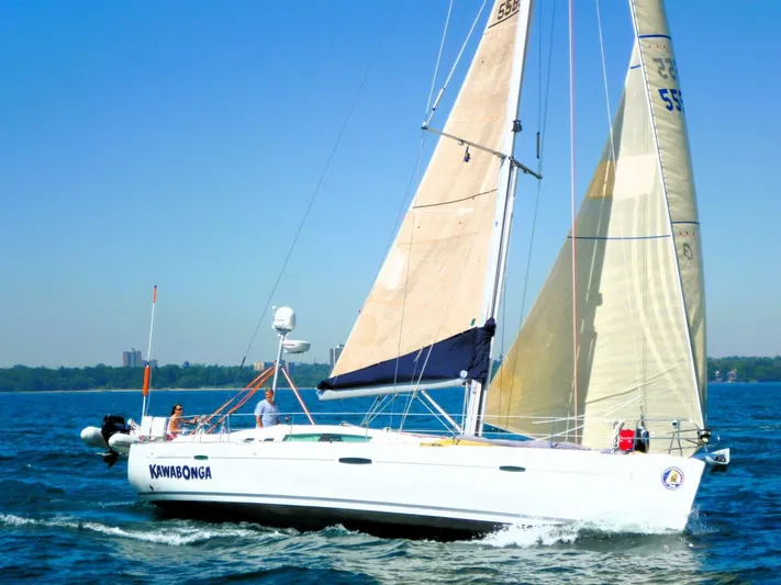  Yacht Photos Pics 2008 Beneteau 49 Oceanis Tall Rig sailing on a clear blue sea.