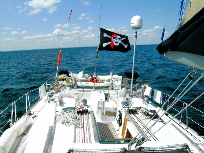  Yacht Photos Pics 2008 Beneteau 49 Oceanis Tall Rig sailboat with pirate flag on open sea.