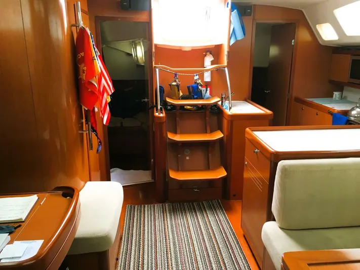  Yacht Photos Pics Interior of 2008 Beneteau 49 Oceanis Tall Rig sailboat, featuring wood finishes and cozy seating.