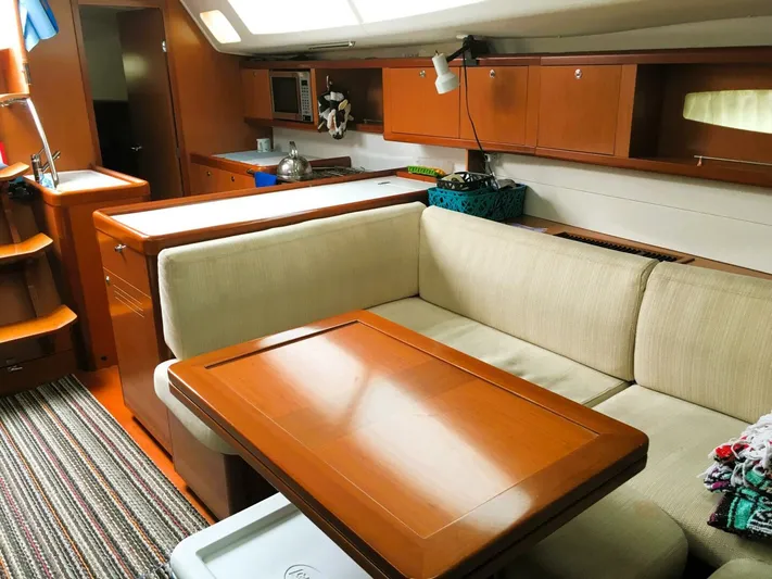 Yacht Photos Pics Interior of 2008 Beneteau 49 Oceanis Tall Rig with cozy seating and wooden table.