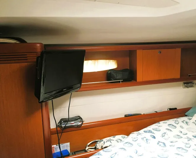  Yacht Photos Pics Interior cabin of 2008 Beneteau 49 Oceanis Tall Rig with TV and wooden storage.