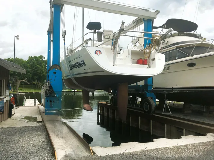  Yacht Photos Pics 2008 Beneteau 49 Oceanis Tall Rig sailboat being lifted at a marina.