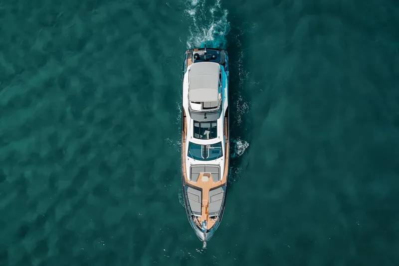  Yacht Photos Pics Aerial view of 2023 Azimut S8 yacht cruising on clear blue water.