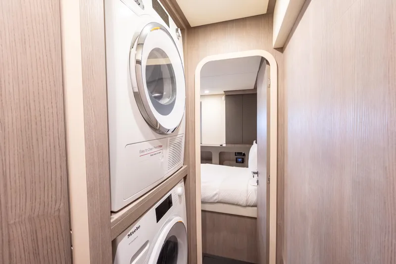  Yacht Photos Pics 2023 Azimut S8 yacht interior with laundry appliances and cozy bedroom.