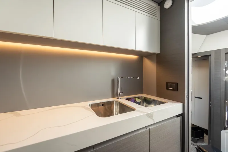  Yacht Photos Pics Modern kitchen interior of 2023 Azimut S8 yacht with sleek design and ambient lighting.