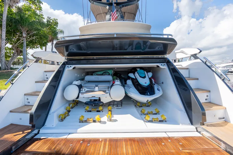  Yacht Photos Pics 2023 Azimut S8 yacht with open garage, featuring watercraft and equipment.