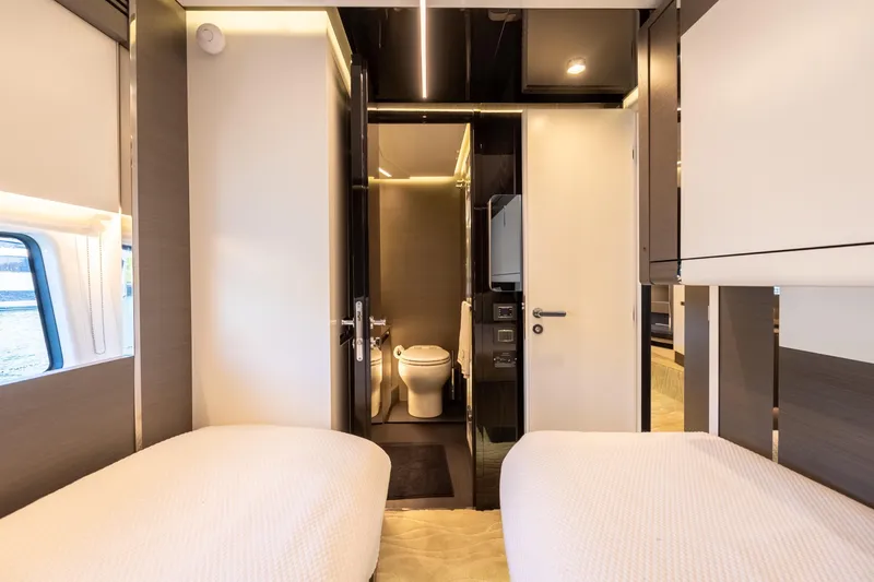  Yacht Photos Pics Luxurious interior of 2023 Azimut S8 yacht with twin beds and modern bathroom.
