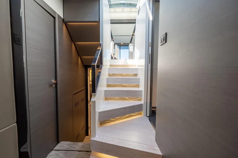  Yacht Photos Pics Interior staircase of 2023 Azimut S8 yacht, featuring modern design and ambient lighting.