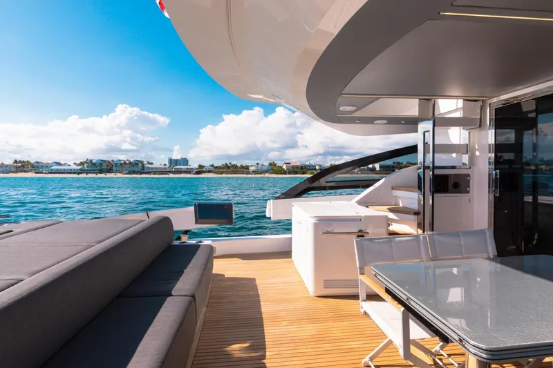 Yacht Photos Pics Luxurious 2023 Azimut S8 yacht deck with seating, table, and ocean view.