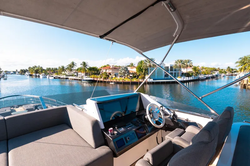  Yacht Photos Pics 2023 Azimut S8 yacht interior with waterfront view, featuring luxurious seating and modern helm.