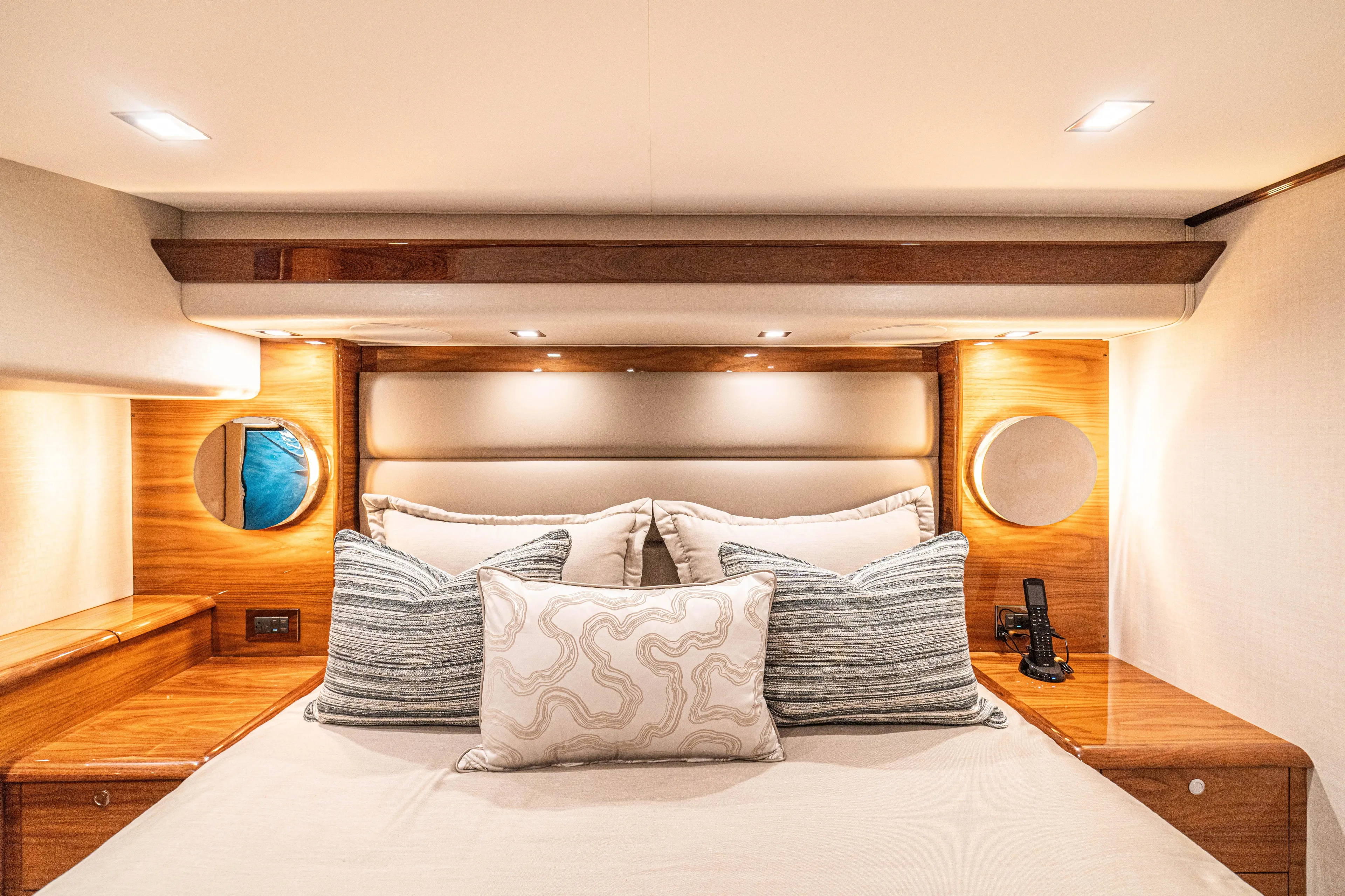 New Viking 64 Convertible Yacht Photos Pics Luxurious bedroom interior of 2026 Viking 64 Convertible yacht with elegant wood accents.