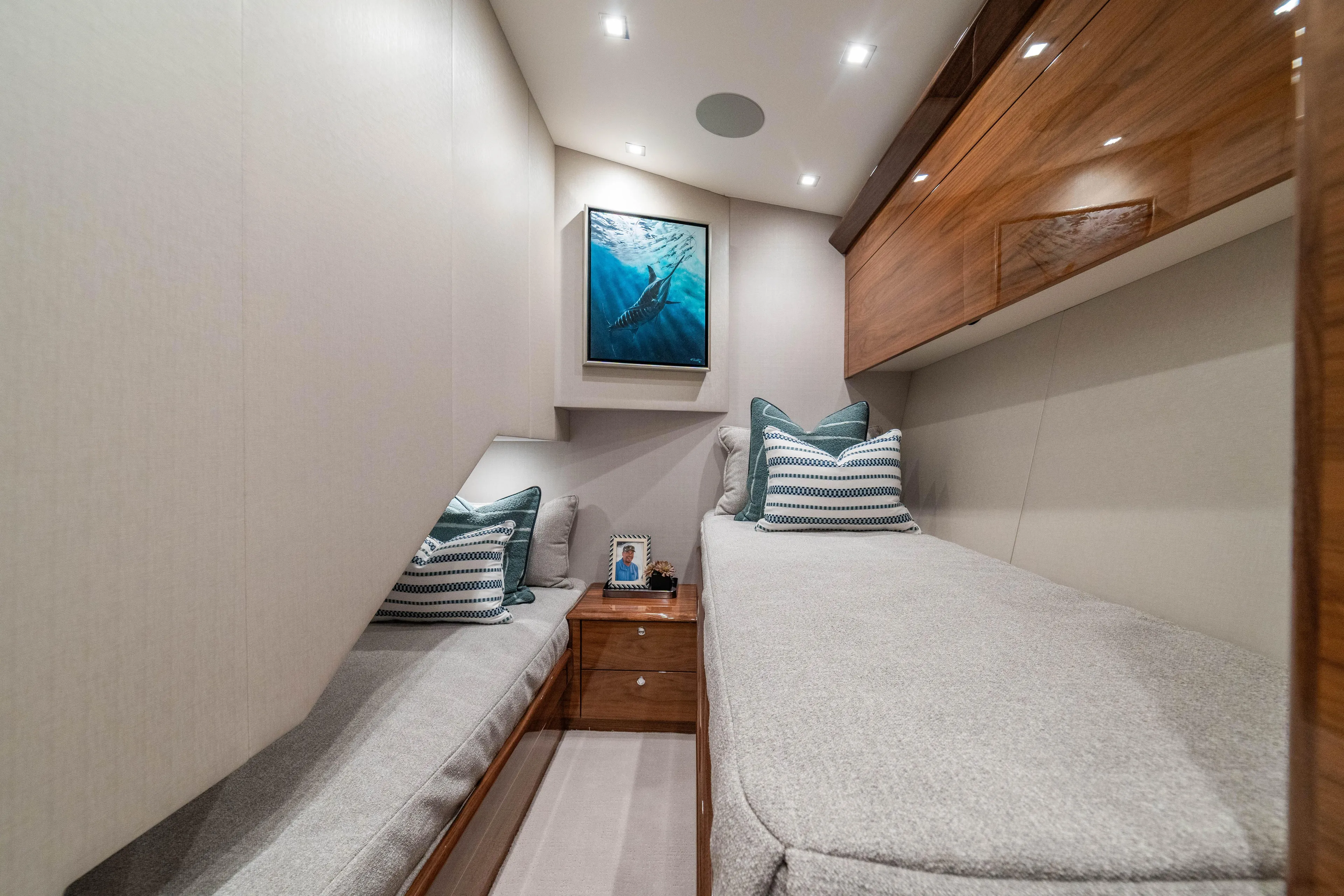 New Viking 64 Convertible Yacht Photos Pics Luxurious cabin interior of 2026 Viking 64 Convertible yacht with elegant decor and cozy bedding.
