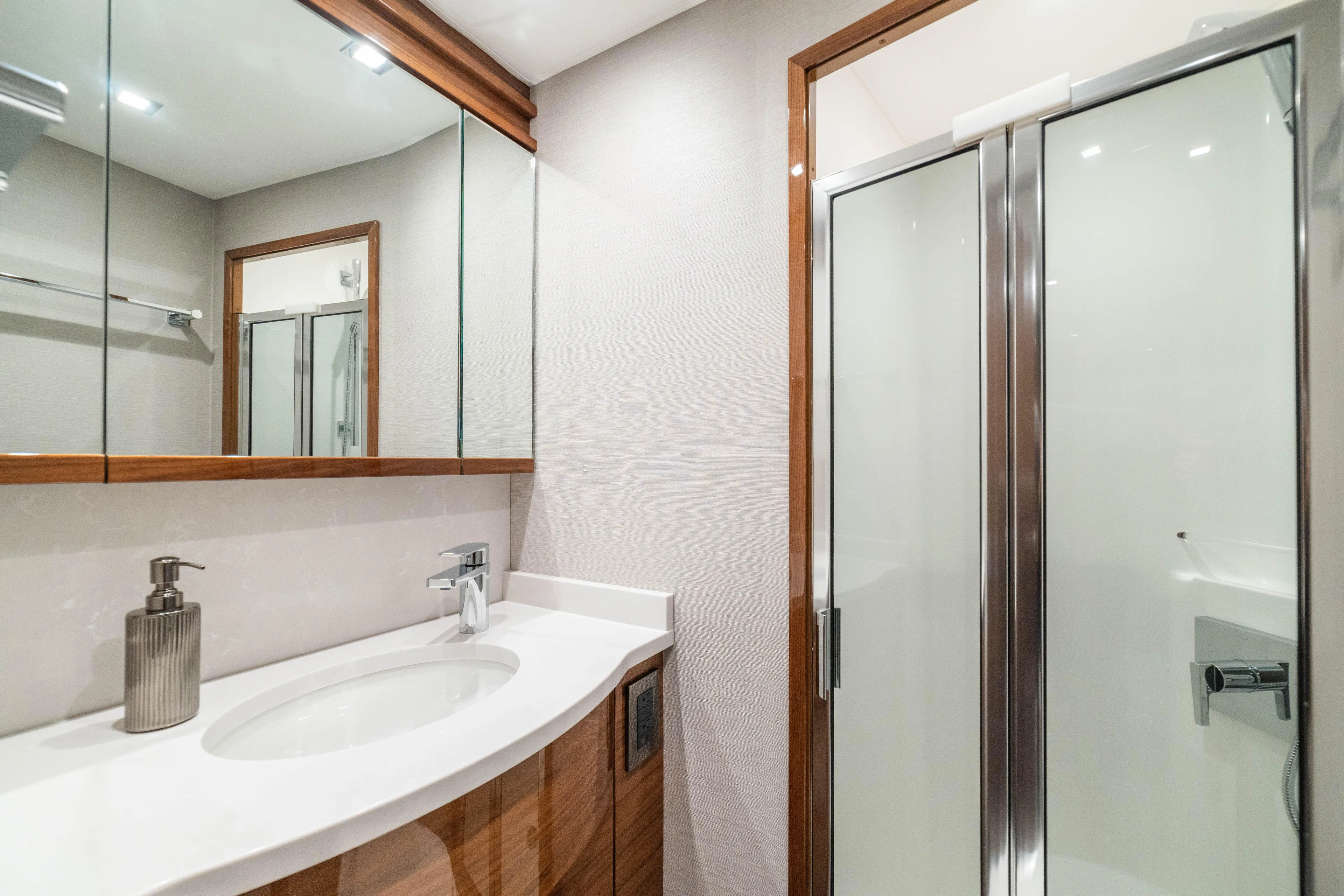 New Viking 64 Convertible Yacht Photos Pics Luxurious bathroom in 2026 Viking 64 Convertible yacht with modern fixtures and glass shower.