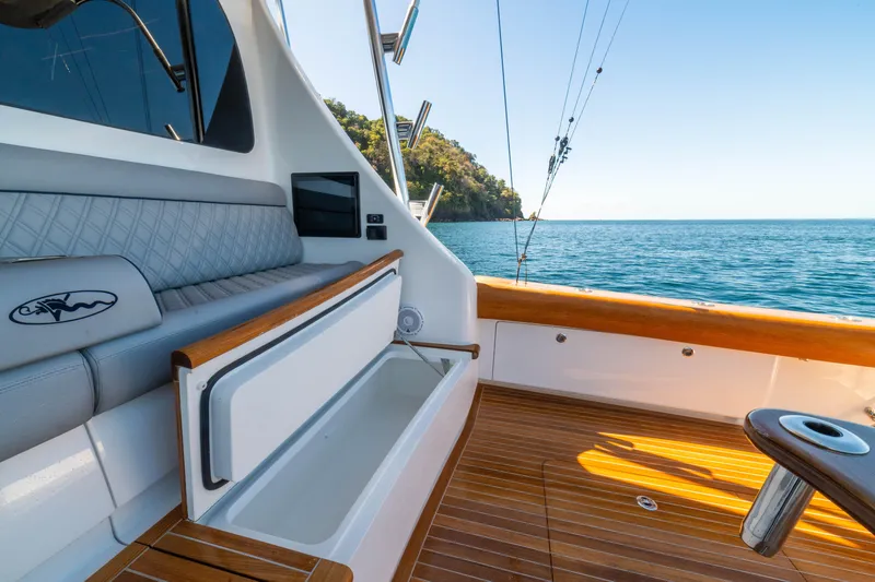 New Viking 64 Convertible Yacht Photos Pics 2026 Viking 64 Convertible yacht deck with seating, ocean view, and fishing rods.