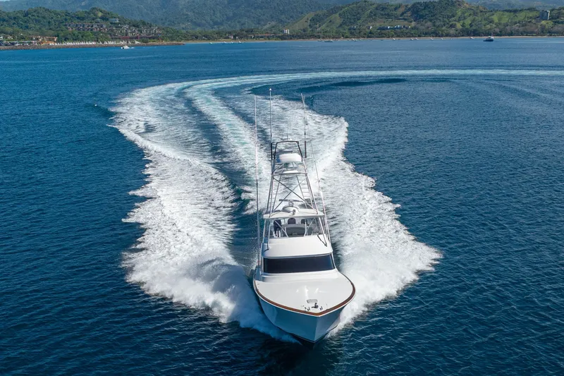 New Viking 64 Convertible Yacht Photos Pics 2026 Viking 64 Convertible yacht cruising on open water with scenic coastline backdrop.