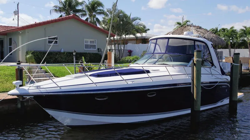 40 Formula Pc / Twin Yanmar / No Pods Yacht Photos Pics 2006 Formula 40 PC yacht docked by a waterfront home with palm trees.