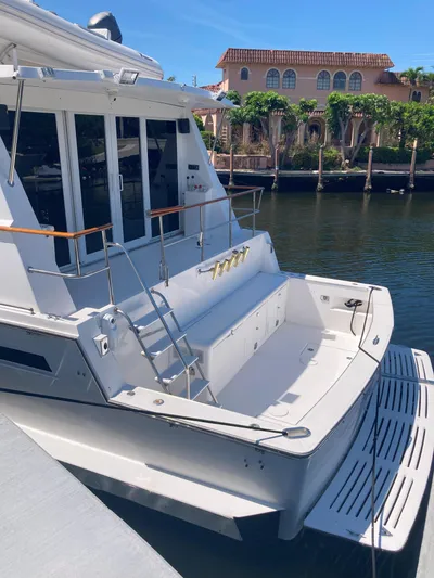 Raiders Yacht Photos Pics 1988 Viking 70 Cockpit Motor Yacht docked in a scenic waterfront location.