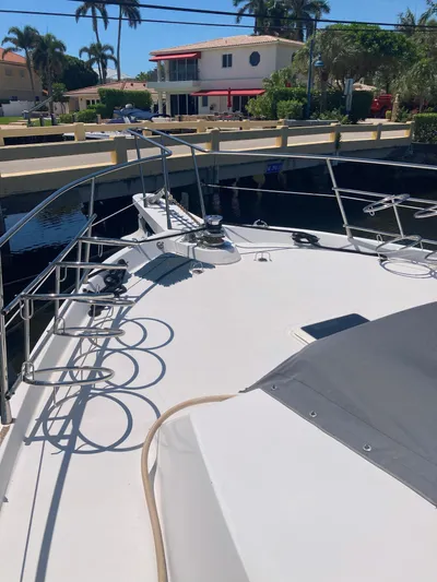 Raiders Yacht Photos Pics 1988 Viking 70 Cockpit Motor Yacht docked near waterfront homes.